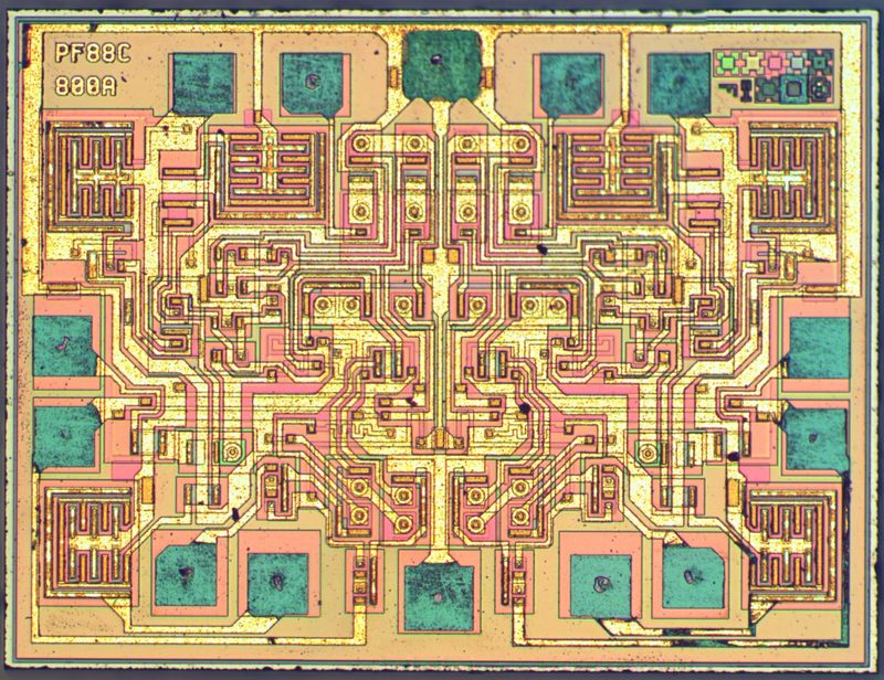 The Dual timer 556 - one of the oldest integrated circuits still being manufactured. Part of the 555 family, a favourite amongst electronic hobbyists. These chips can be used as timers, oscillators and flip-flops. The silicon elements shown here are acting as transistors, diodes and resistors. The size of this die is 0.2066cm by 0.1576cm. From the insides of microchips.